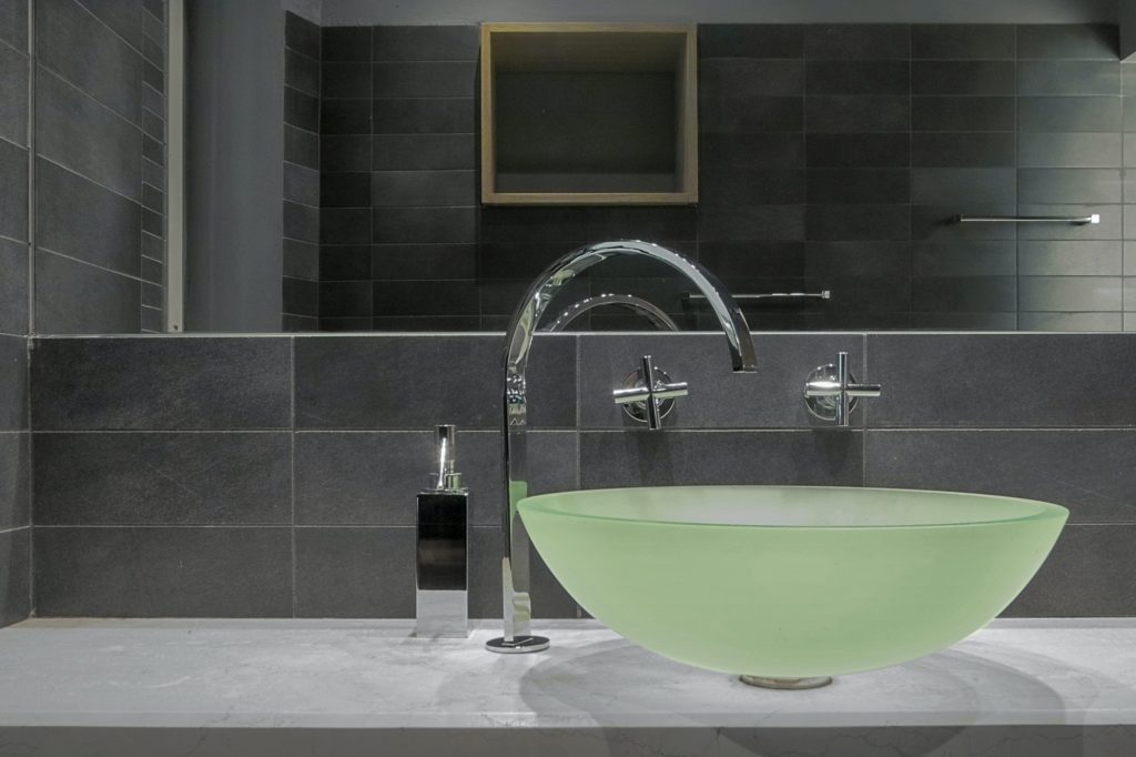 Close-Up of a Glass Countertop Washbasin in the Modern Bathroom Interior