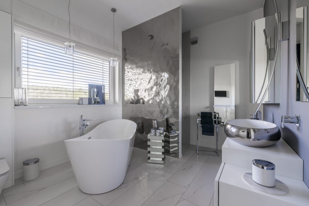 Glamor bathroom interior with trendy grey design with white furniture