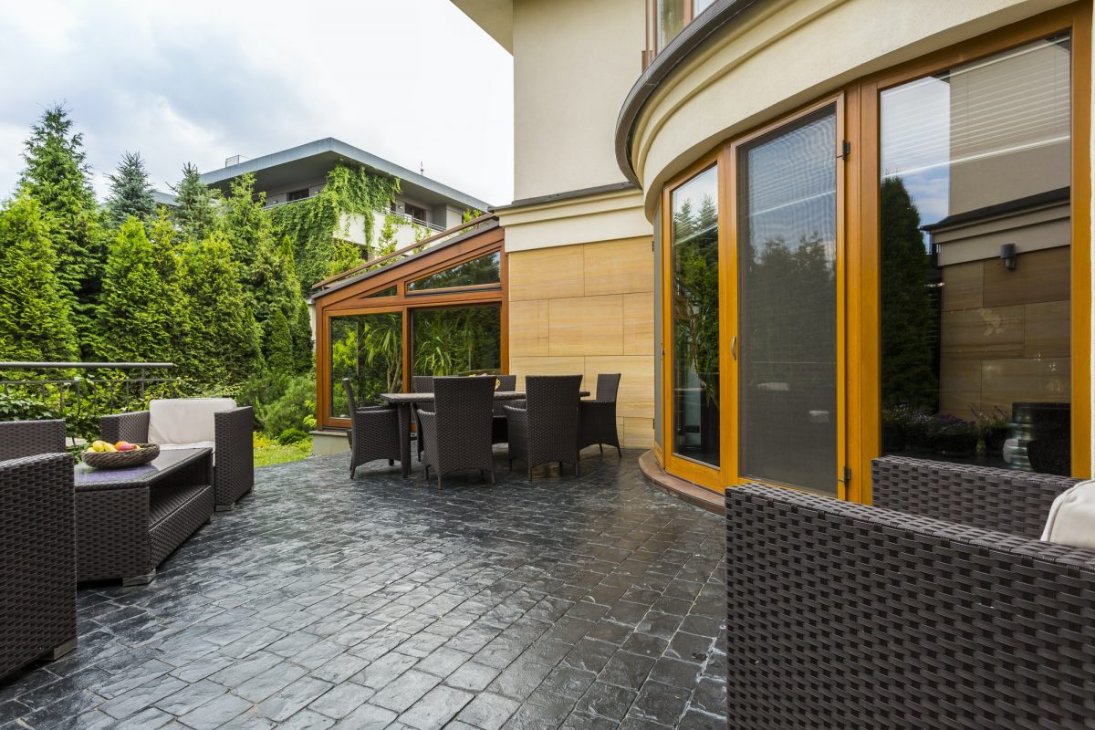 Elegant backyard terrace with rattan furniture